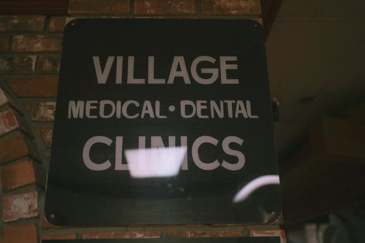 a black and white sign that says village medical dental clinic