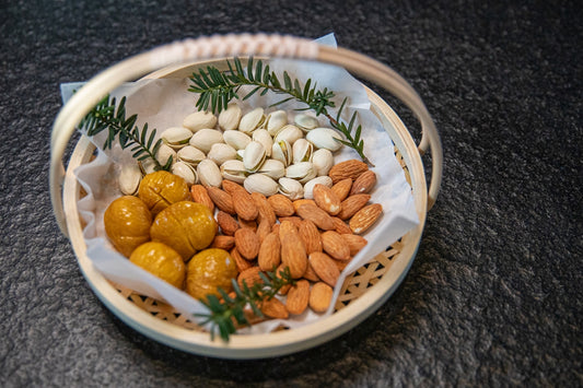a basket filled with nuts and almonds on top of a table