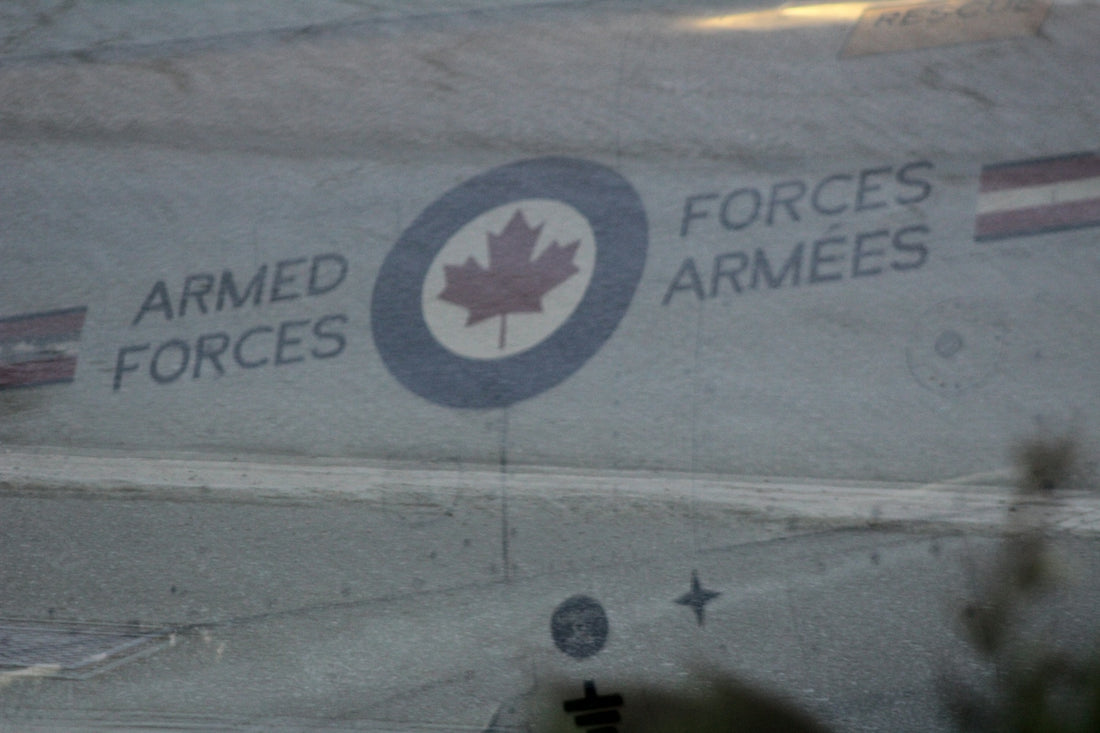 Canadian armed forces logo on a grey surface.
