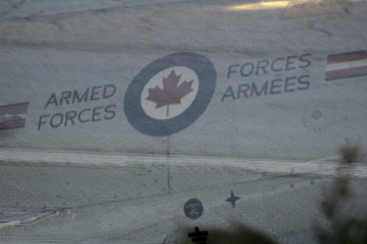 Canadian armed forces logo on a grey surface.