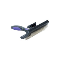 Self-cleaning slicker brush soft pins